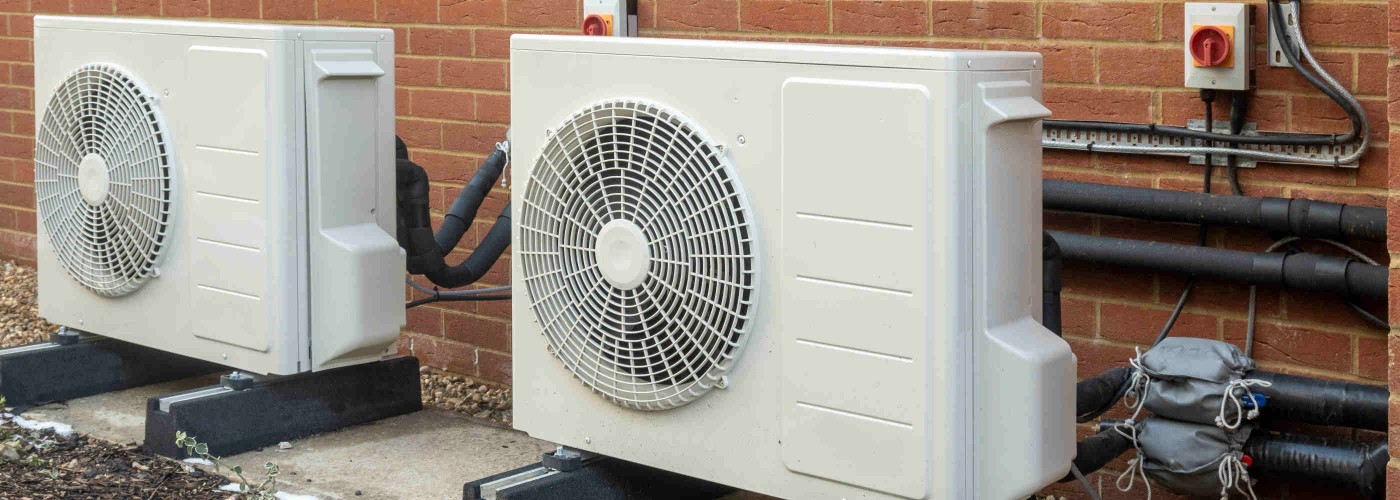 Two air source heat pump units installed on a modern house