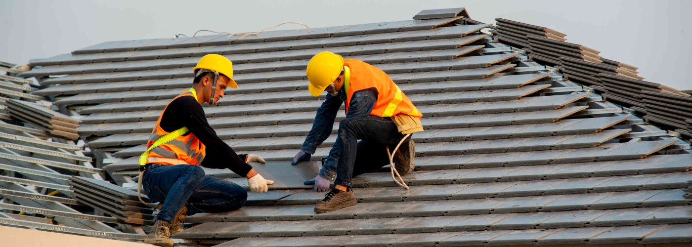 Roofer working on roof structure are installing new roof,Two roofers inspecting new roof.